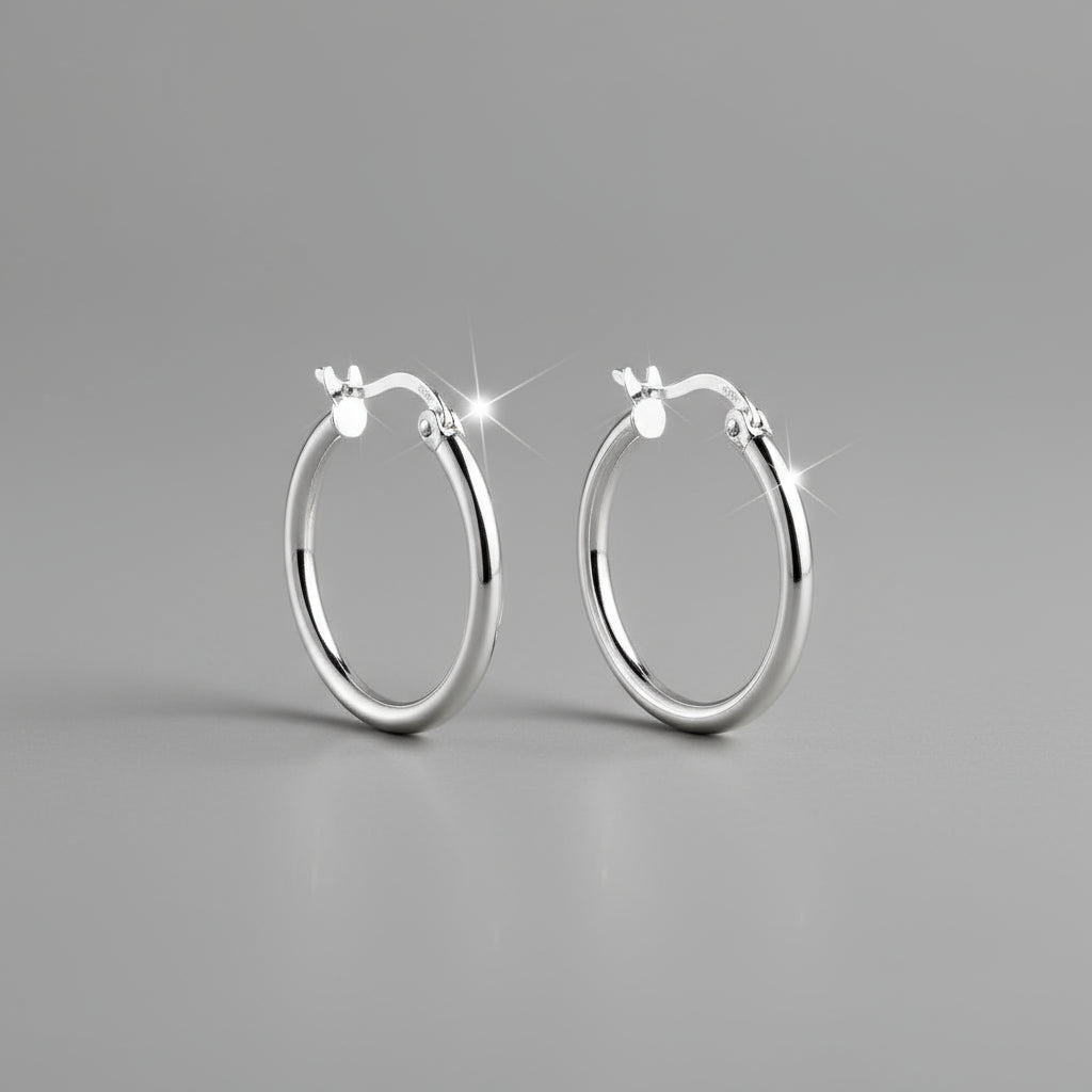 Pair of silver hoop earrings on a white background