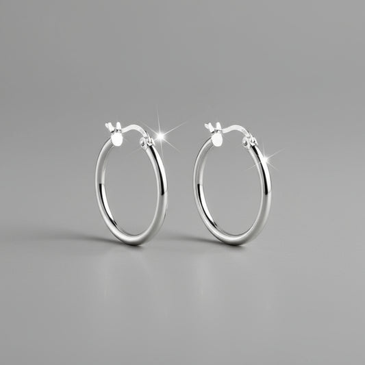Pair of silver hoop earrings on a white background