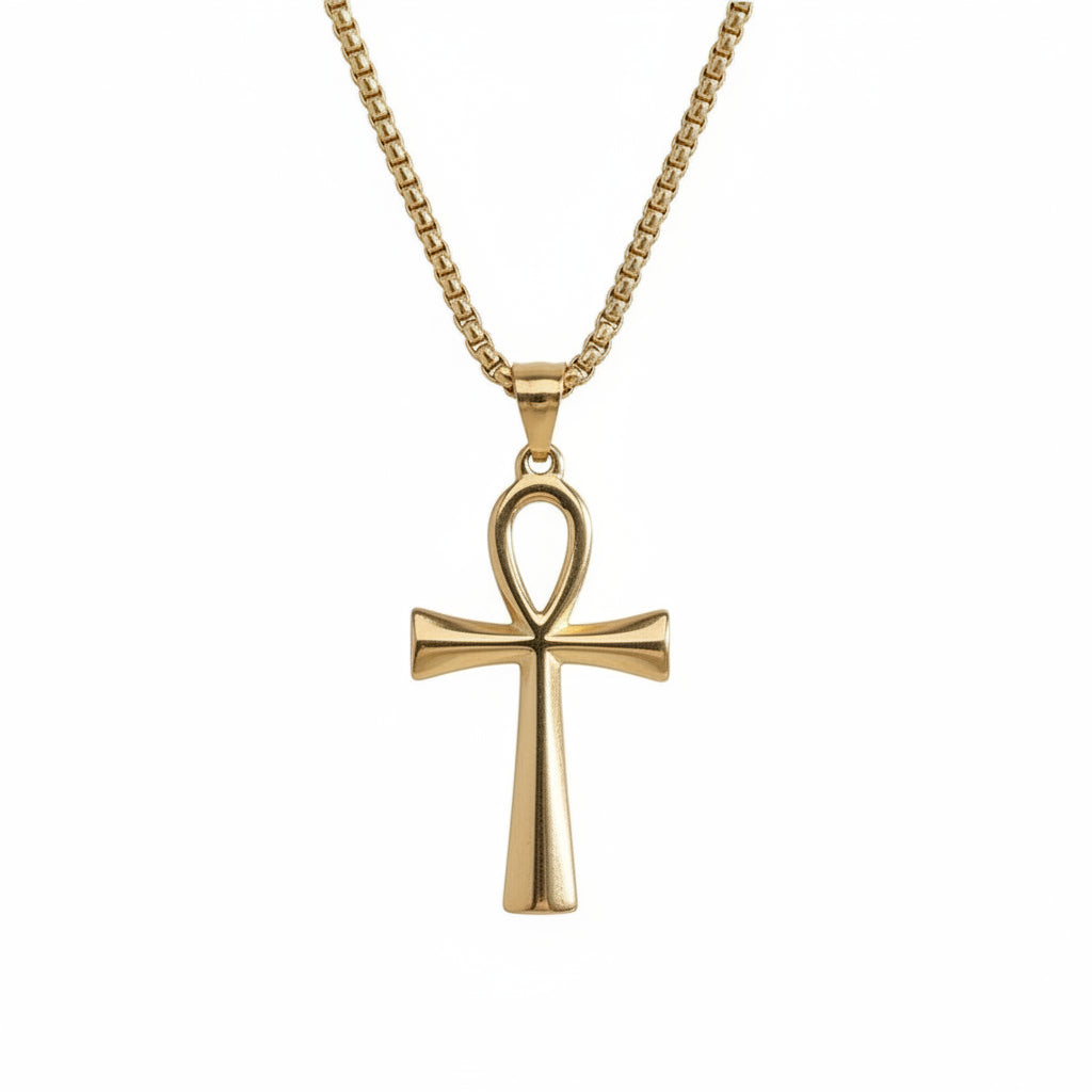 Gold cross pendant necklace on a white background