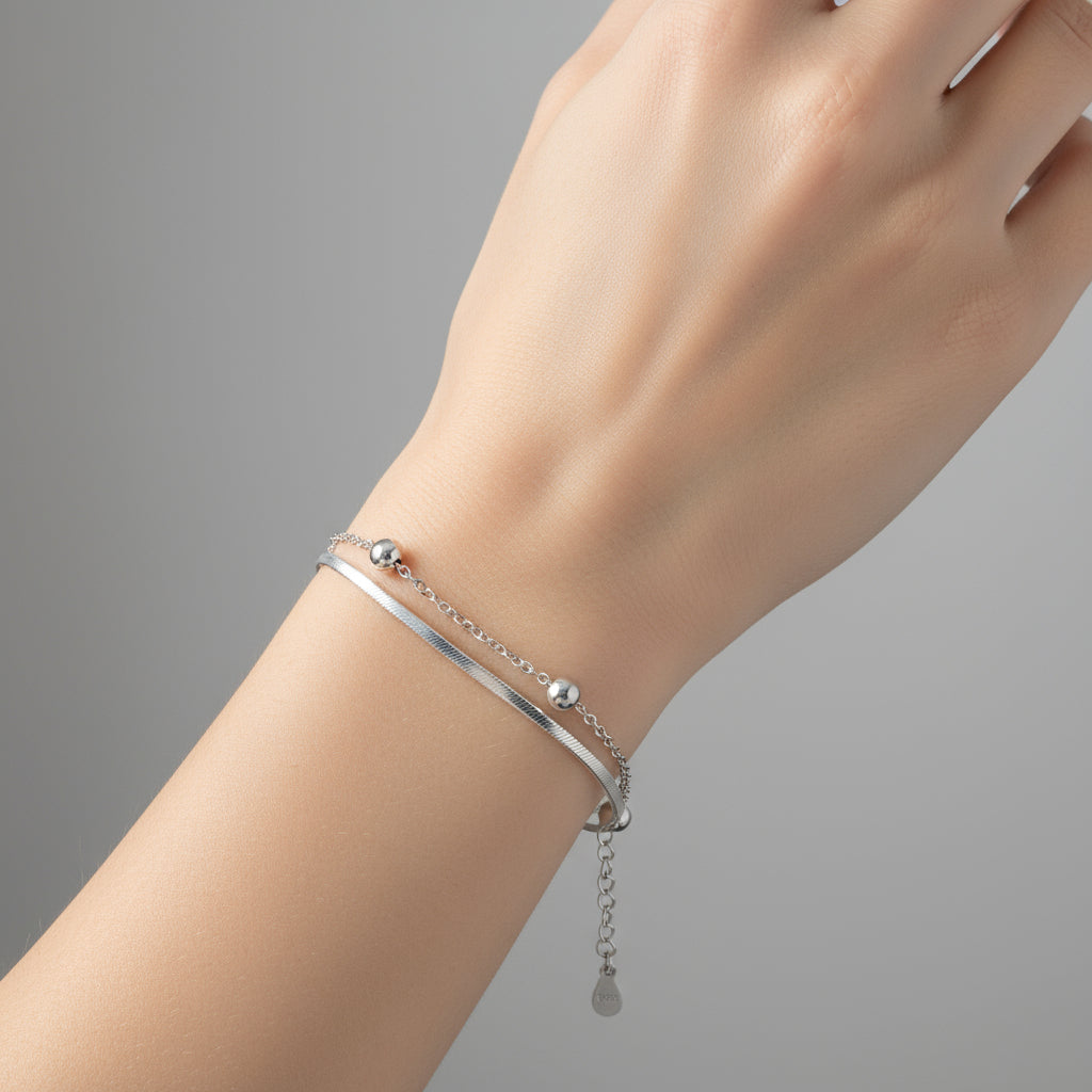 Silver bracelet with beads on a white background