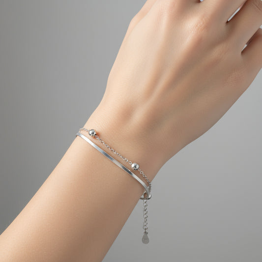 Silver bracelet with beads on a white background