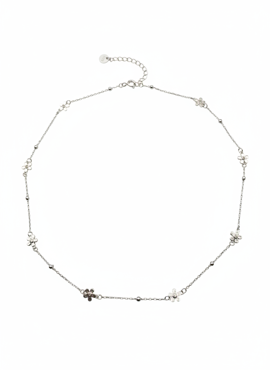 Silver necklace with small floral pendants on a white background