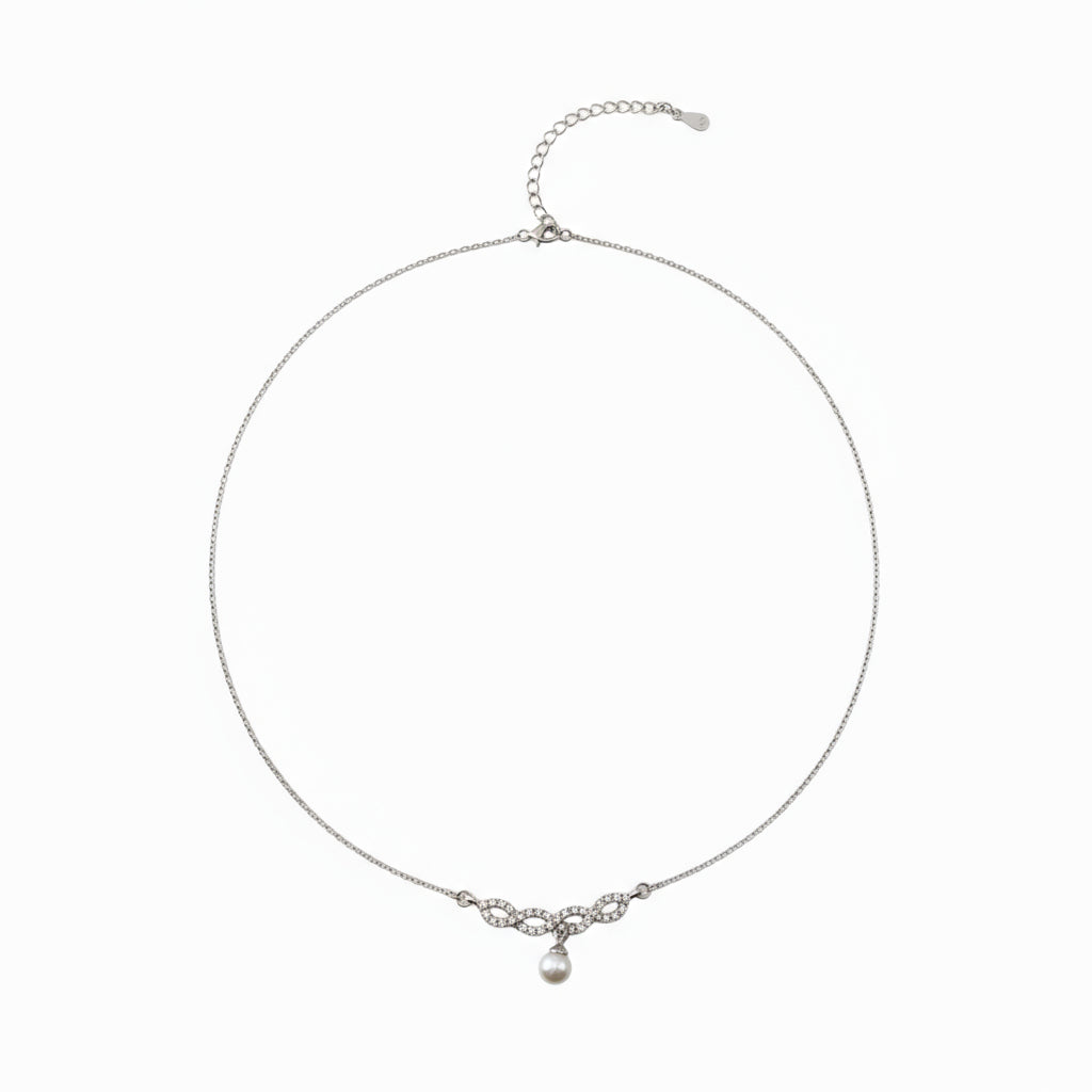 Silver necklace with a small pendant on a white background