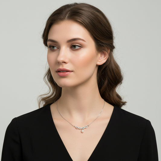Silver necklace with a small pendant on a white background