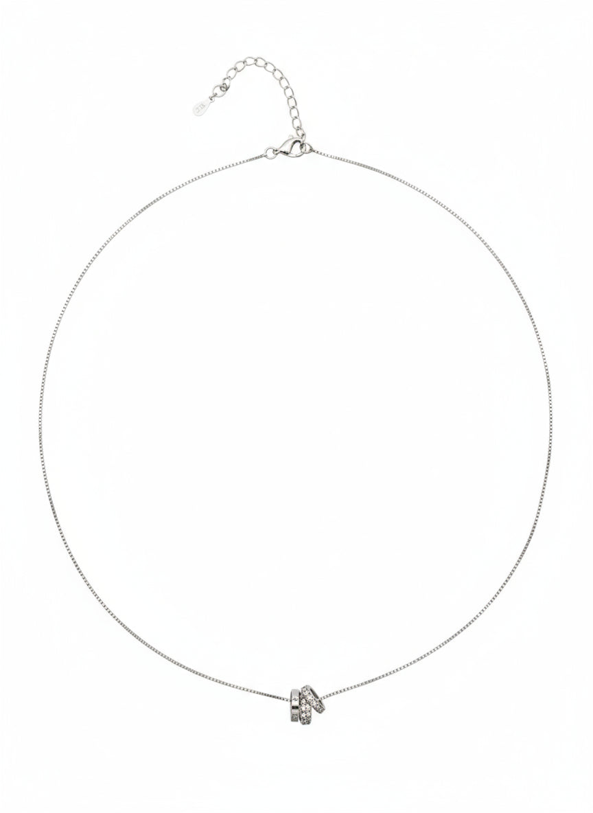 Silver necklace with a small pendant on a white background
