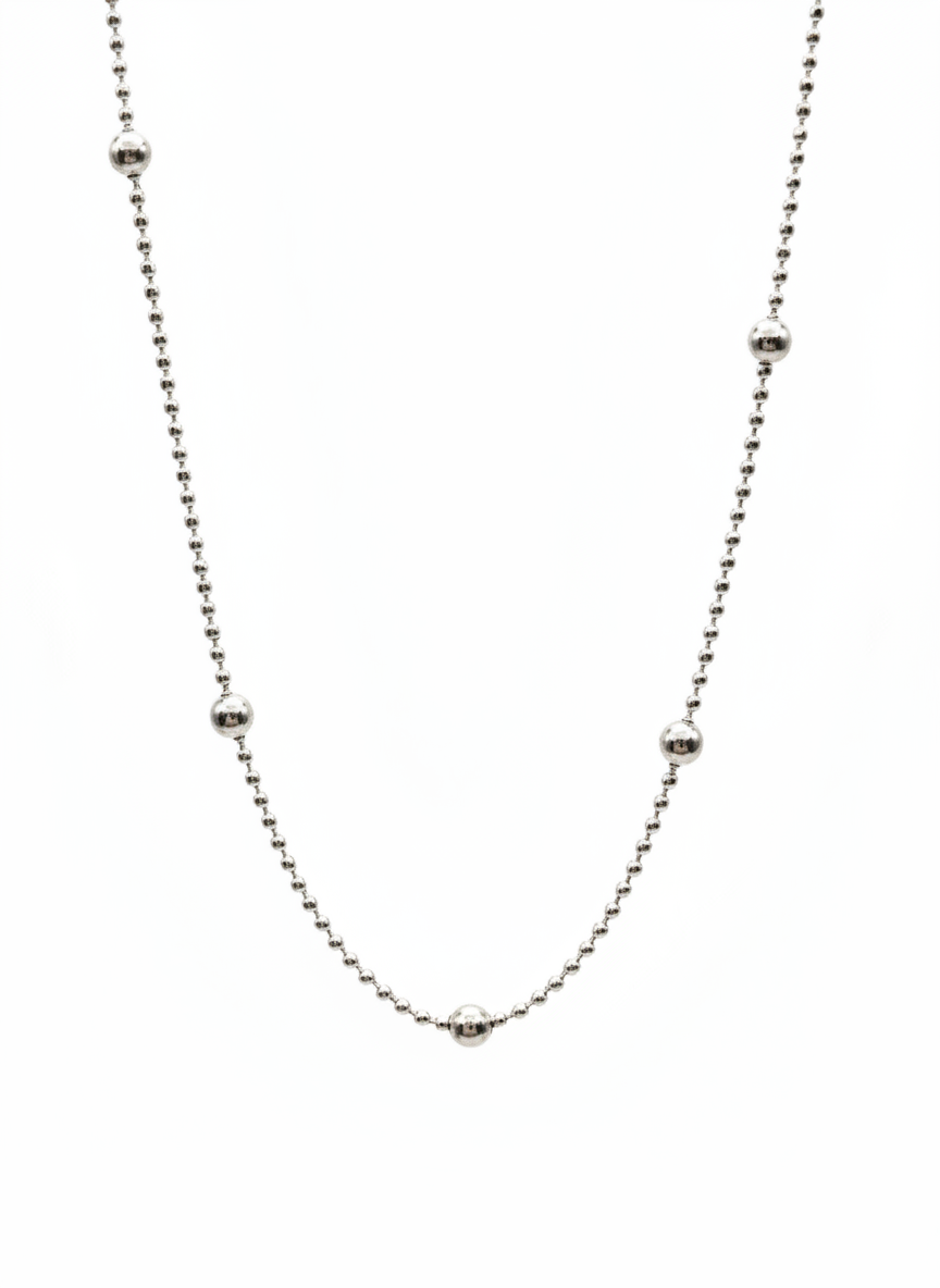 Thin silver chain necklace on a white background