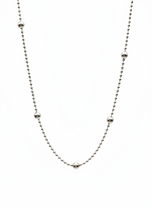 Thin silver chain necklace on a white background