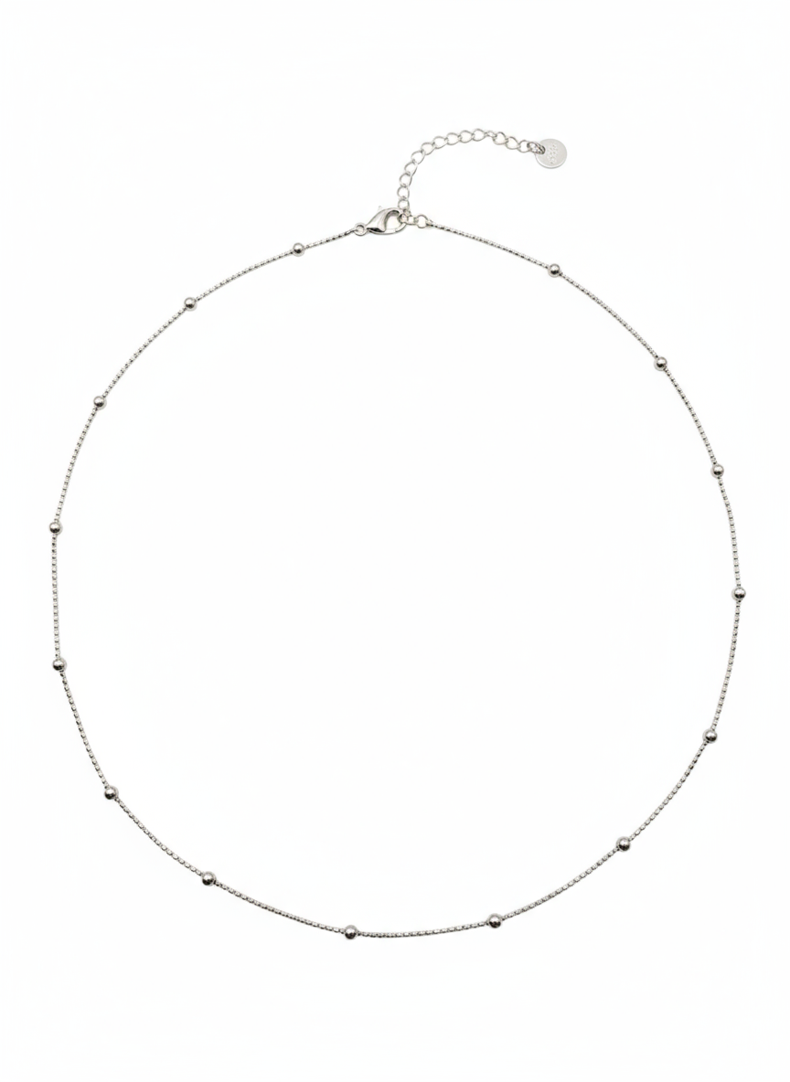 Silver necklace with small beads on a white background