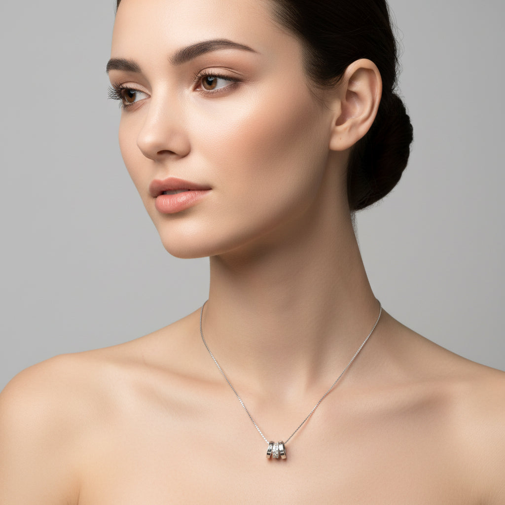 Silver necklace with a small pendant on a white background