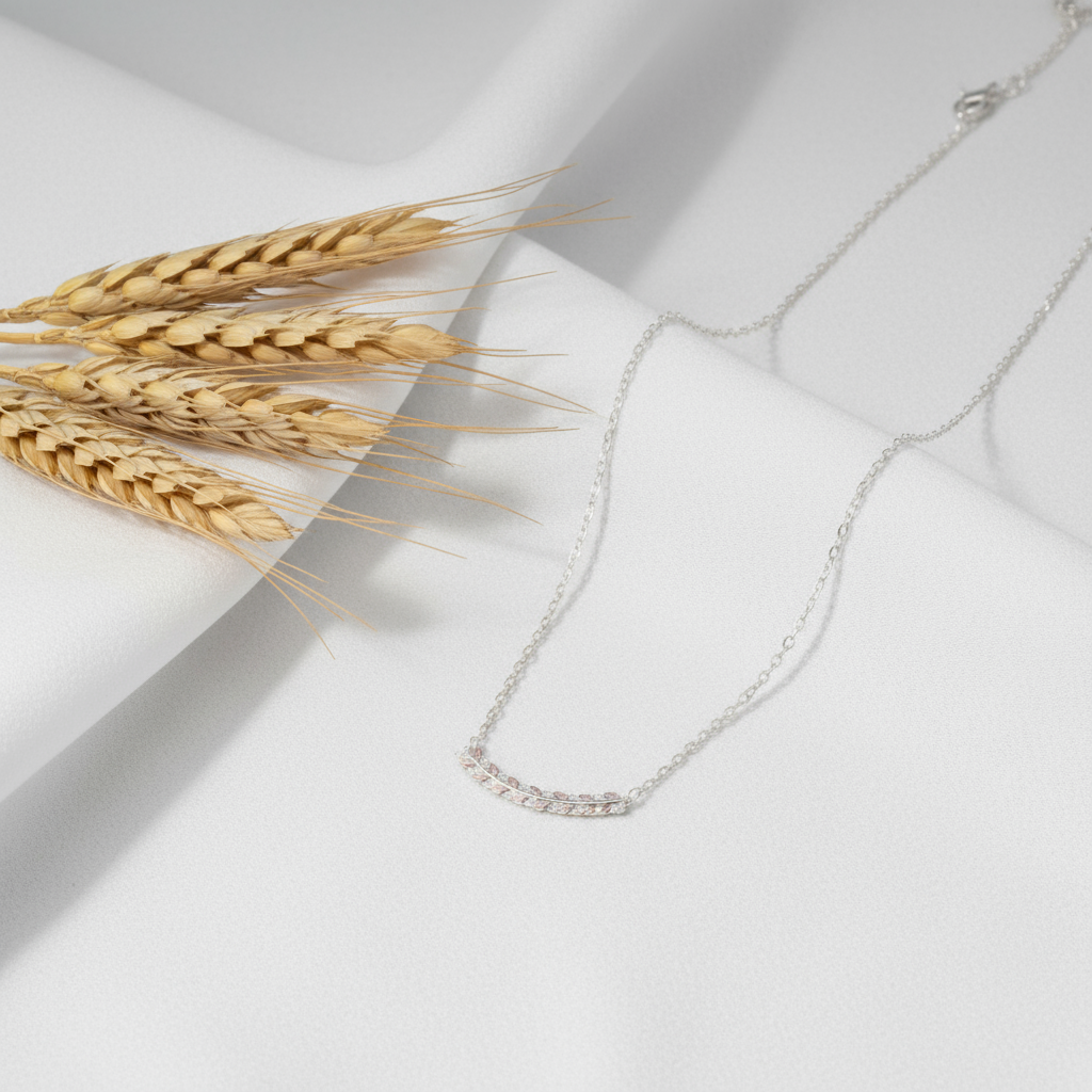 Silver necklace with a subtle design on a white background