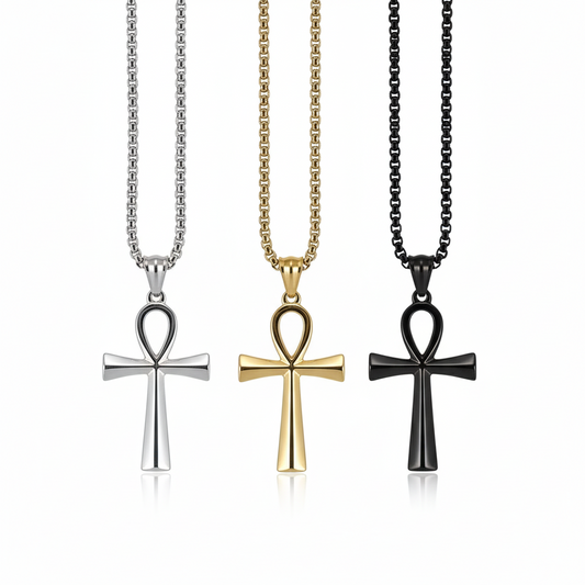 Three cross-shaped pendants on chains against a white background