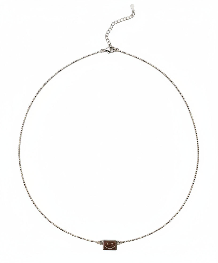 Necklace with a small square pendant on a white background
