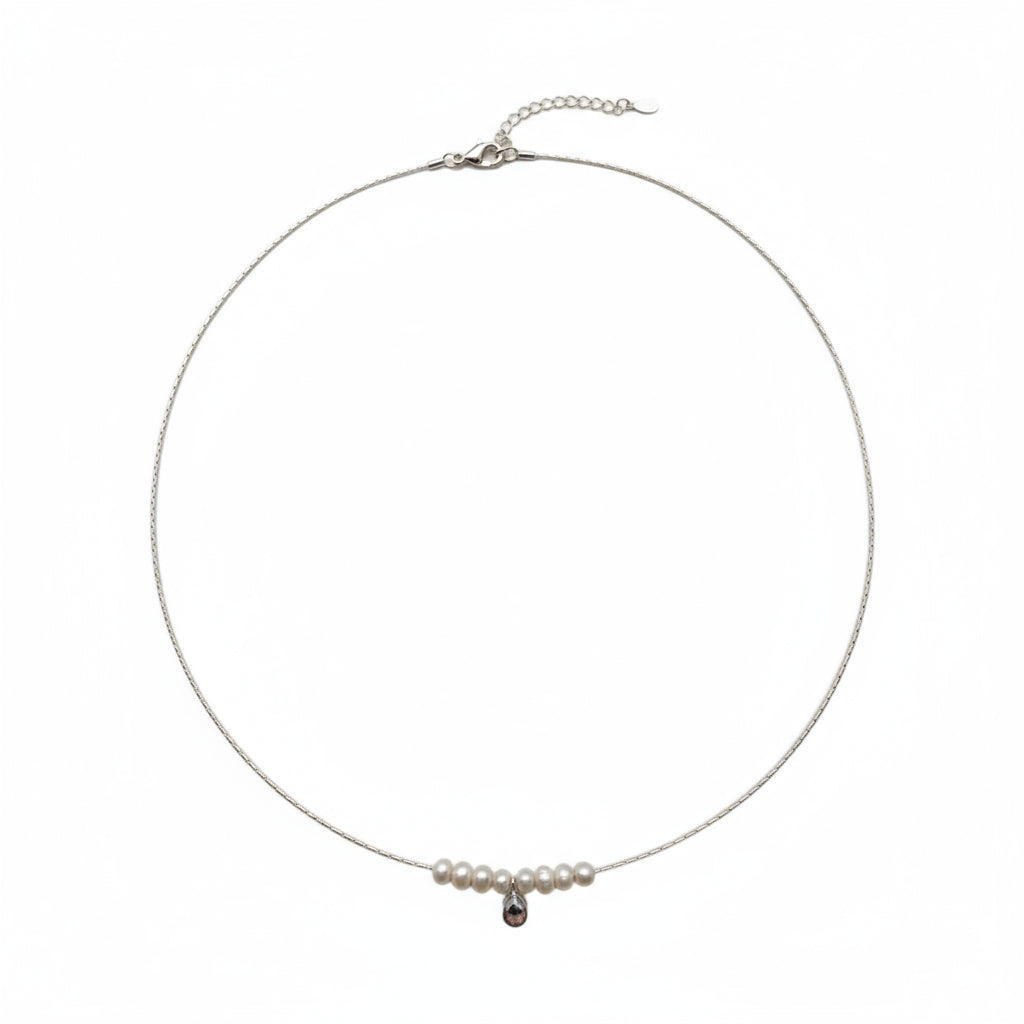 Necklace with pearls and a black pendant on a white background