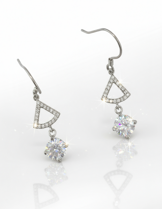 Pair of silver earrings with triangular designs and clear cubic zirconia on a white background