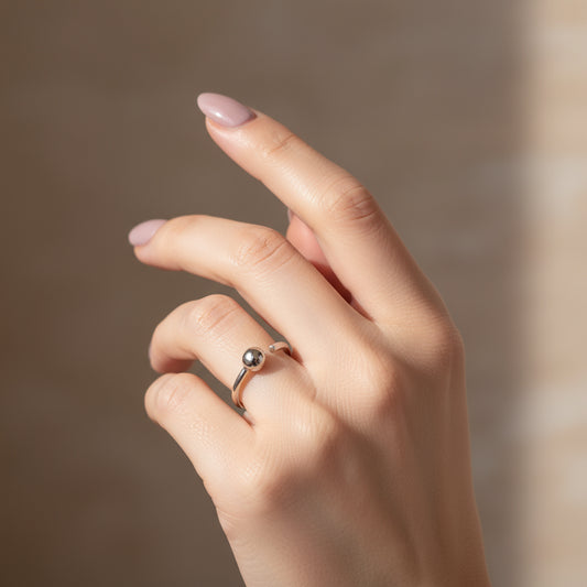 Silver nose ring with a ball on a white background