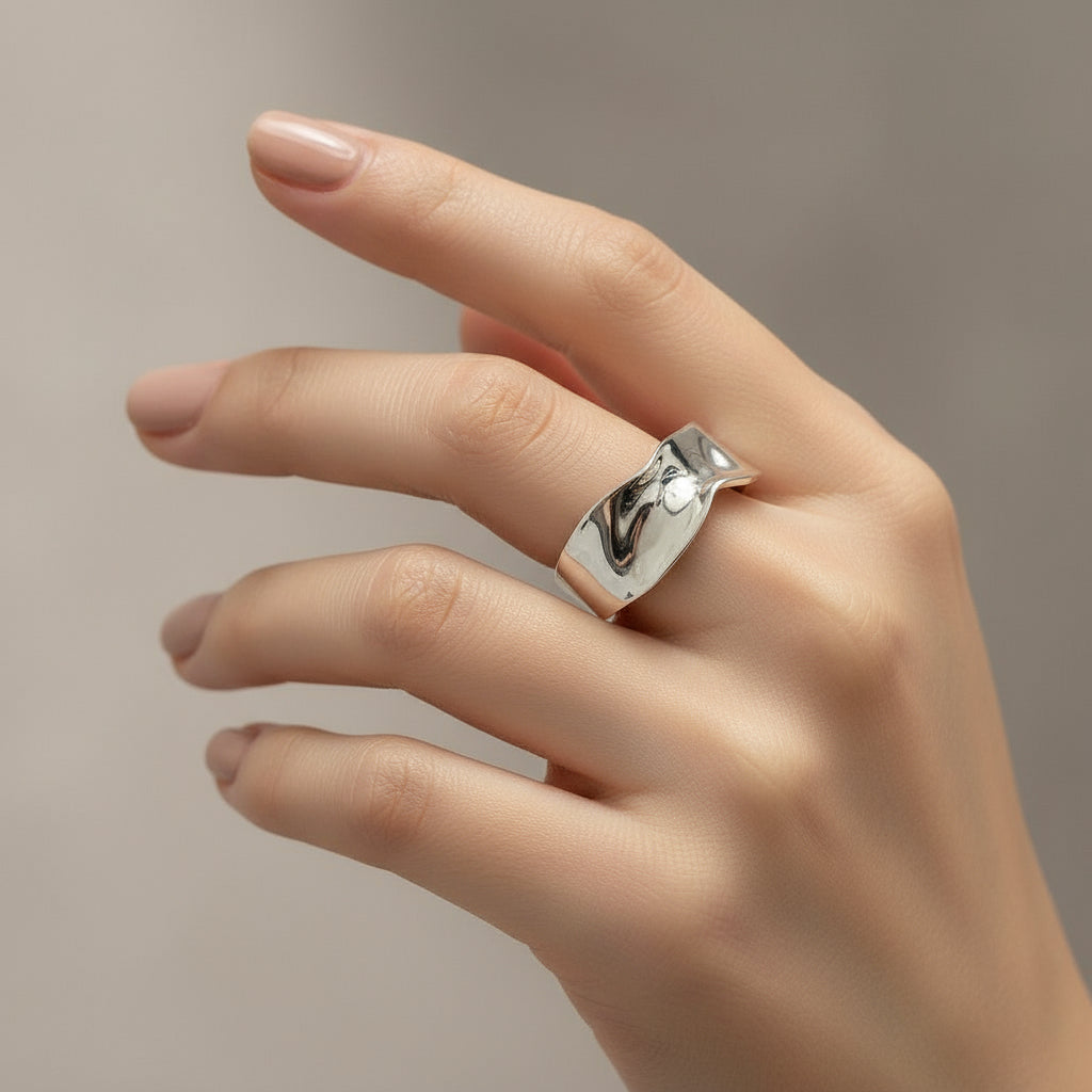 Silver ring on a light gray background