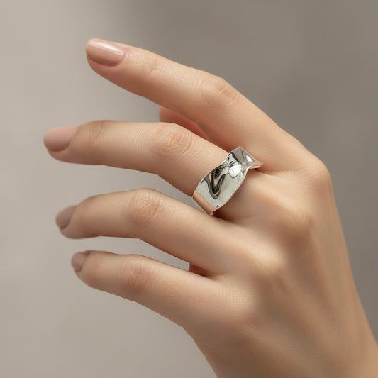 Silver ring on a light gray background