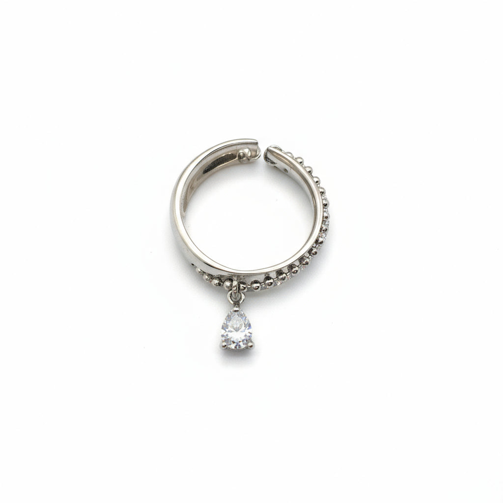 Silver hoop earring with a small gemstone on a white background
