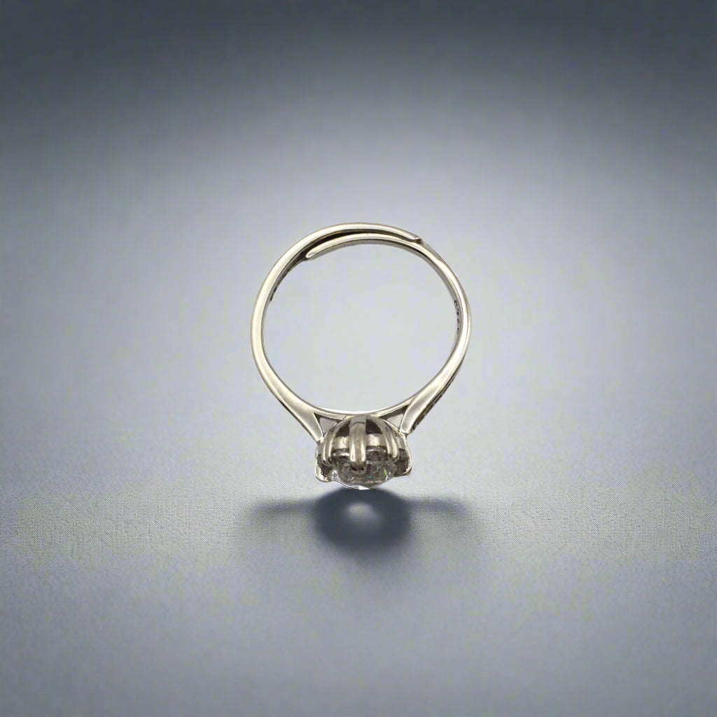 Silver ring with a small stone on a white background