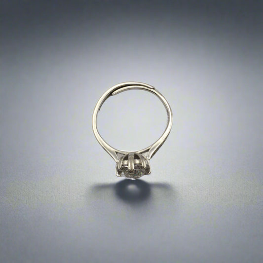Silver ring with a small stone on a white background