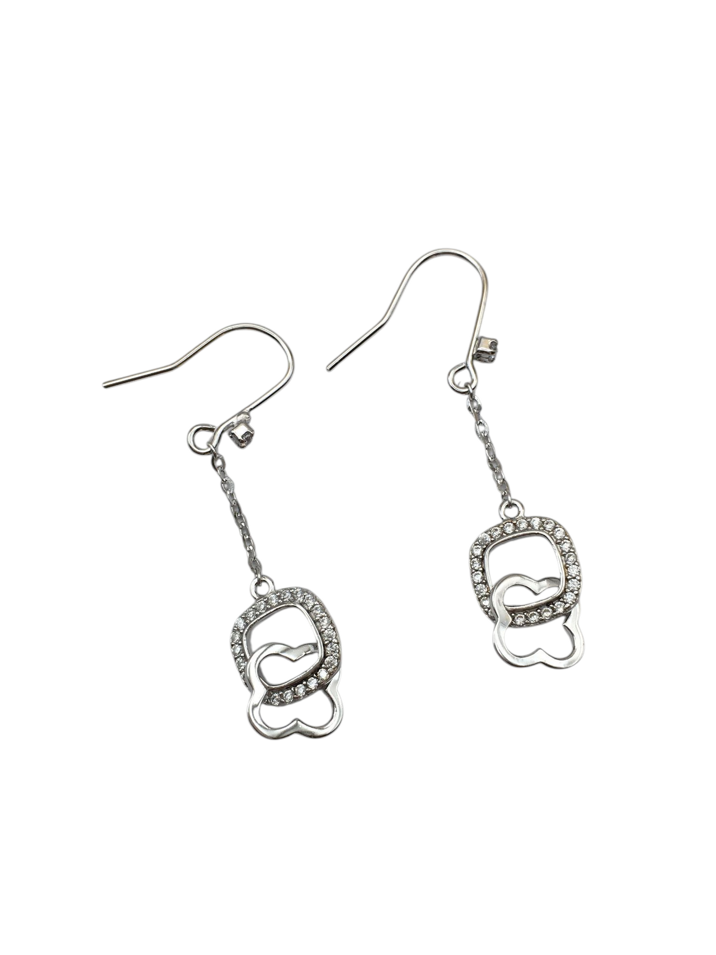 Pair of silver earrings with heart designs on a white background