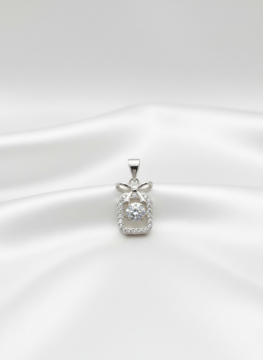 silver pendant with diamond accents on a white background
