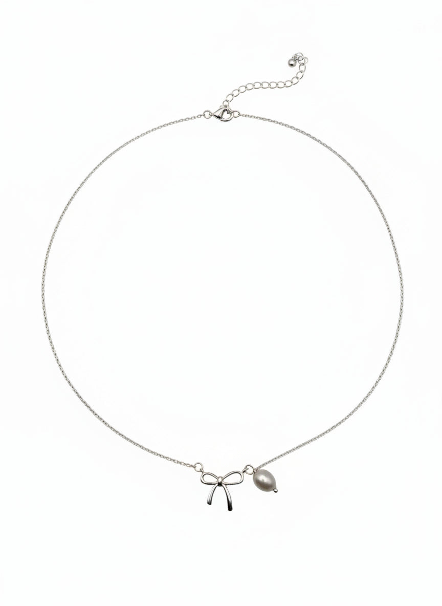 Necklace with bow and leaf pendant on a white background