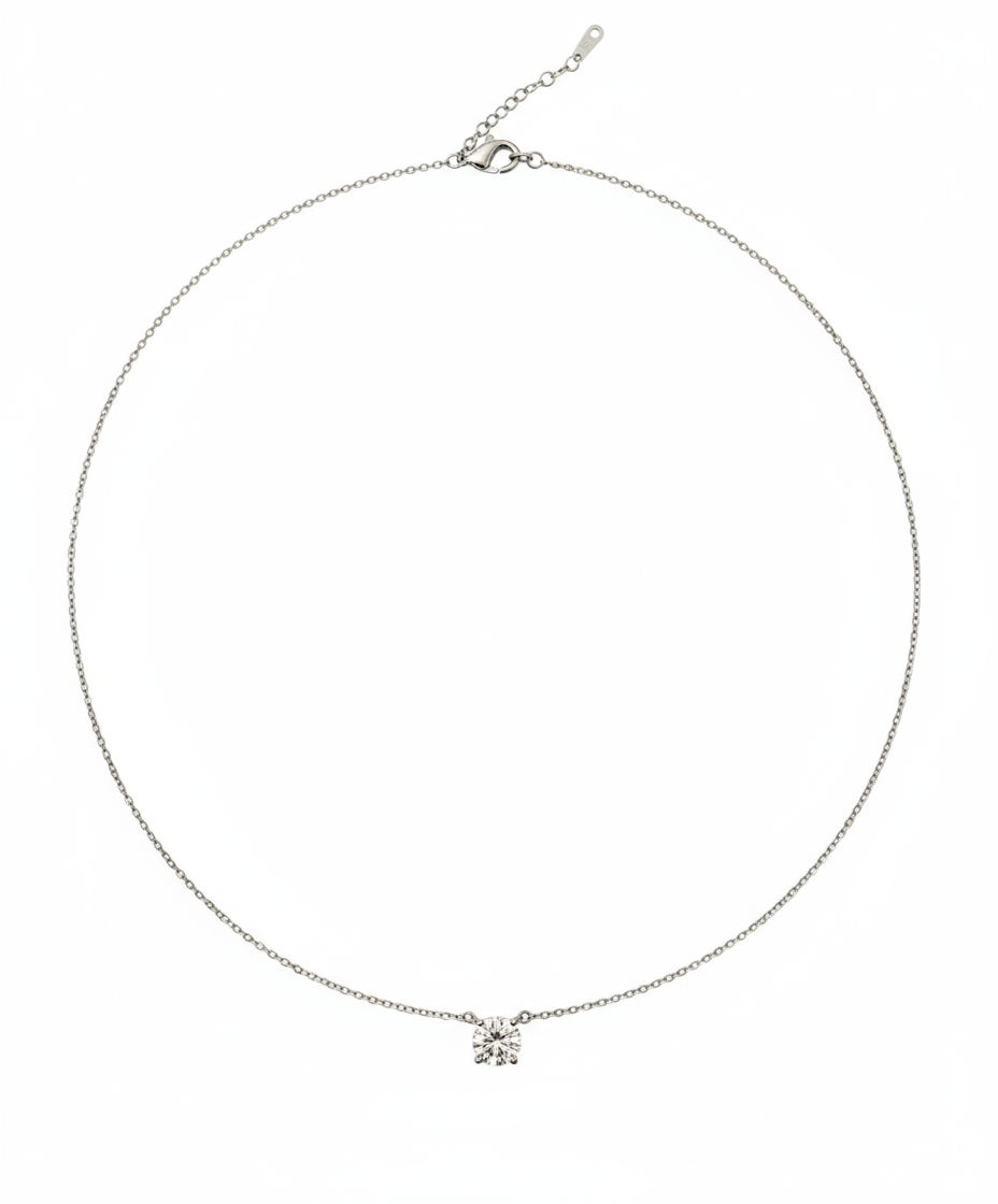 Silver necklace with a small pendant on a white background