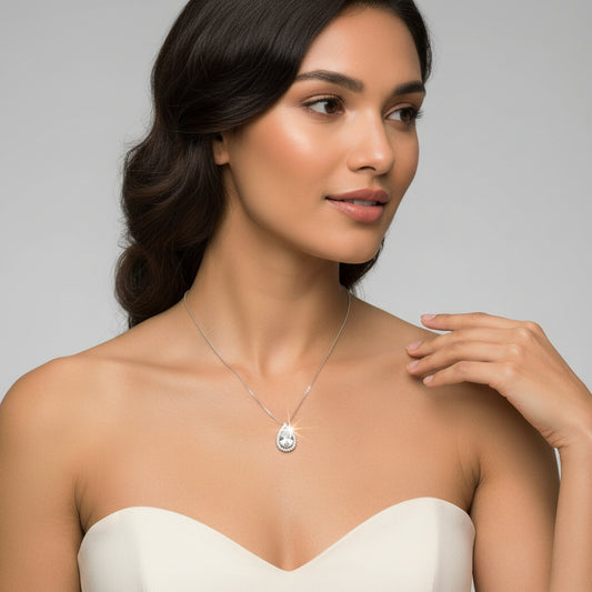 Delicate necklace with a teardrop-shaped pendant on a white background