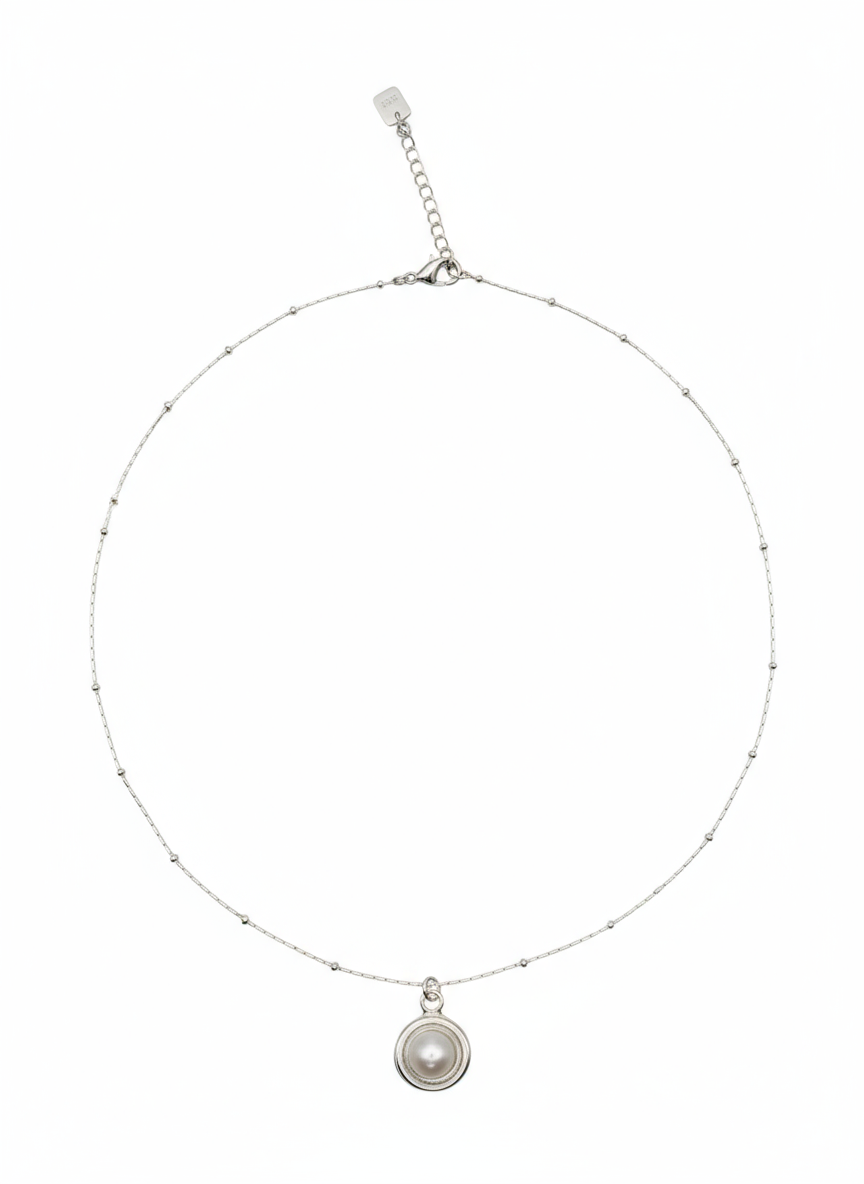 Silver necklace with a pendant on a white background