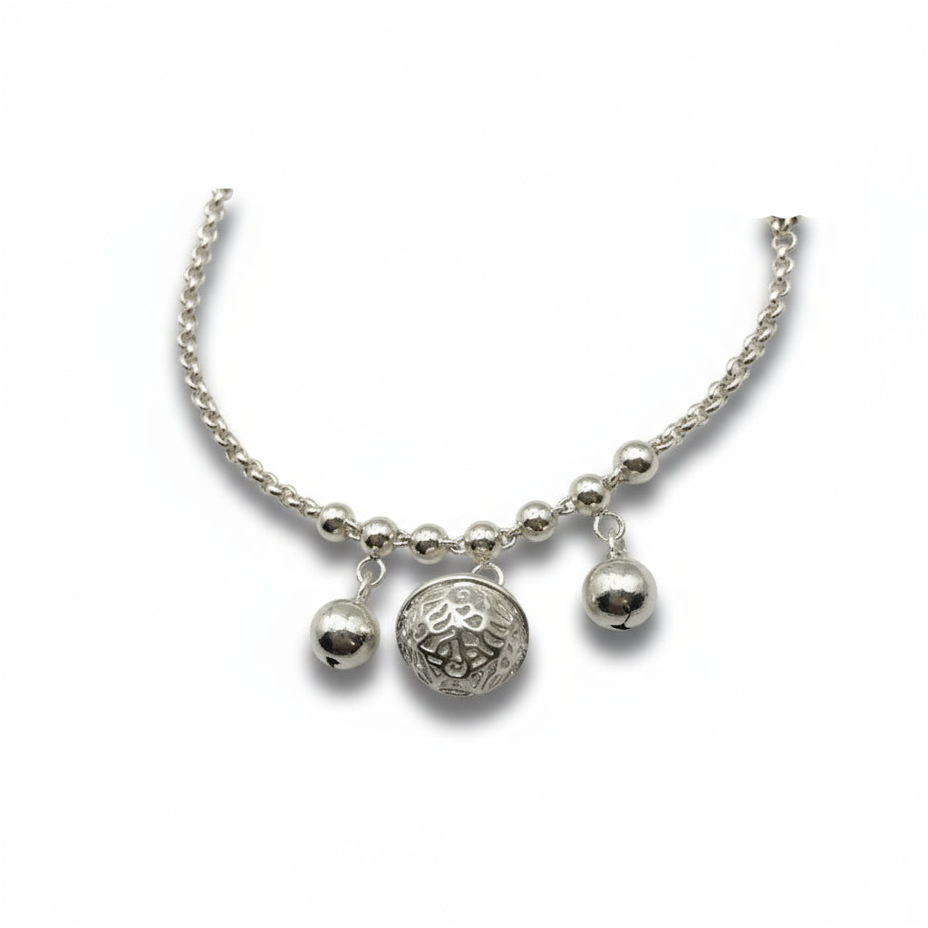 Silver bracelet with three charms on a white background