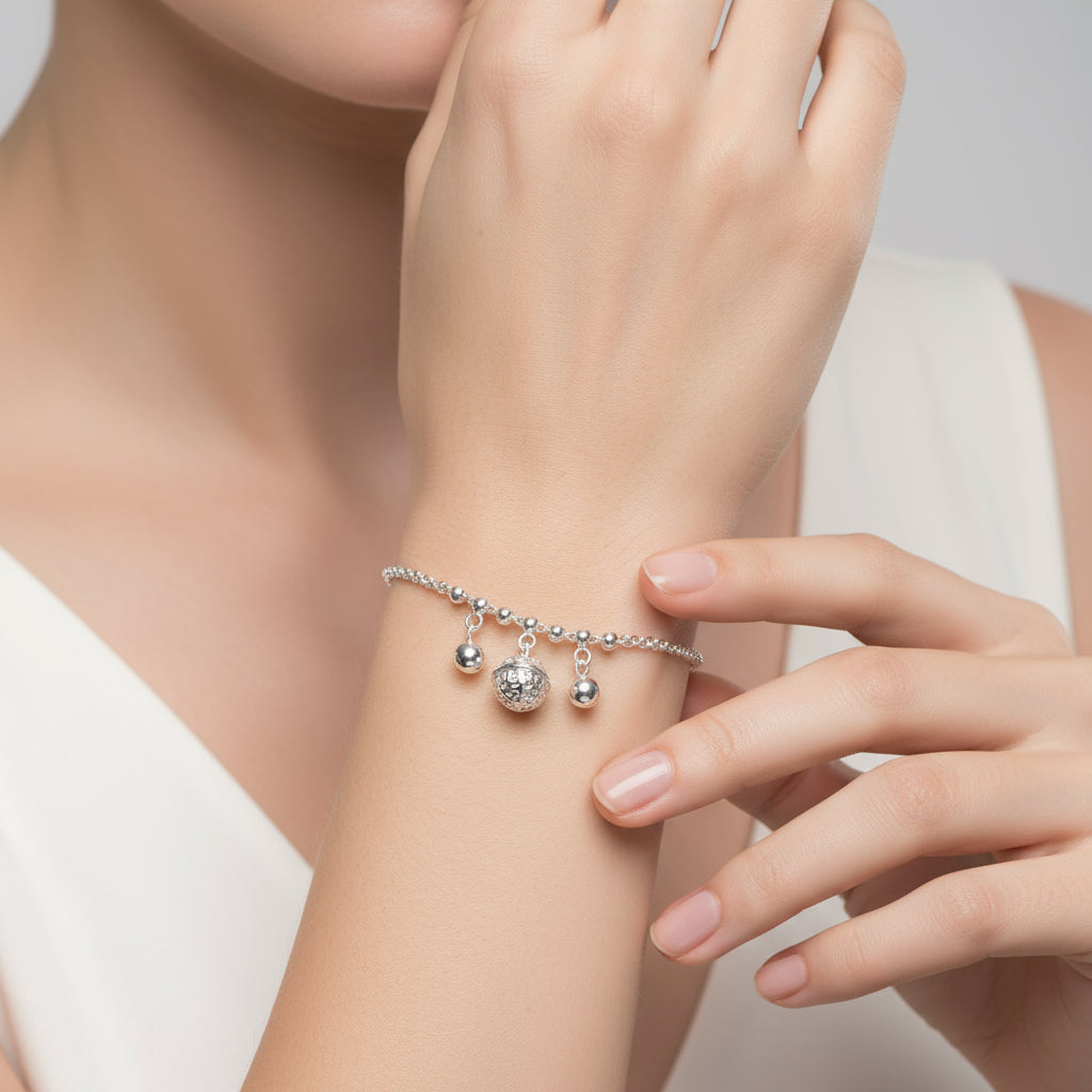 Silver bracelet with heart pendant on a white background