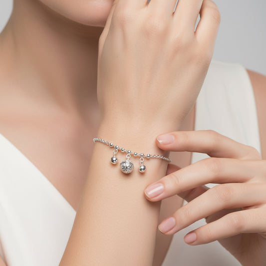 Silver bracelet with heart pendant on a white background