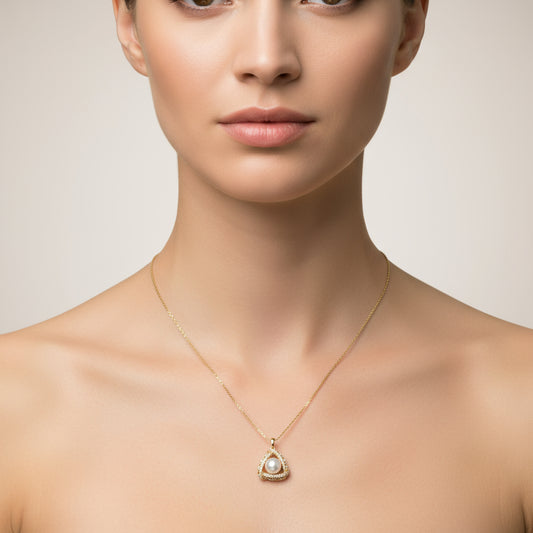 Gold necklace with a teardrop-shaped pendant on a white background