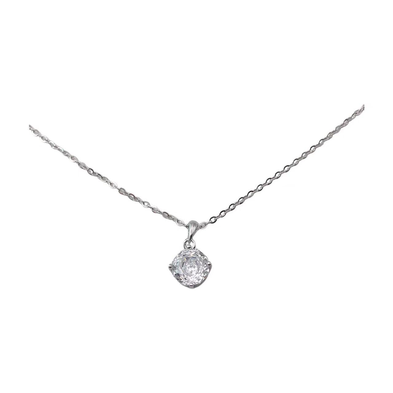 Silver necklace with a round pendant on a white background