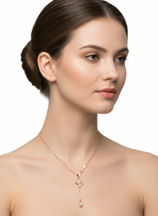 Delicate necklace with butterfly and pearl pendant on a white background