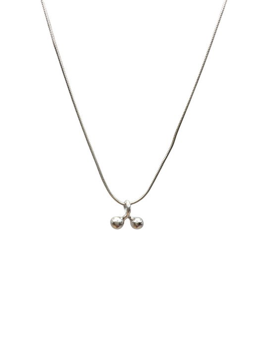 Silver necklace with a small pendant on a white background