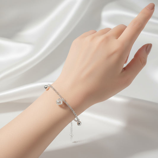 Silver bracelet with charms on a white background