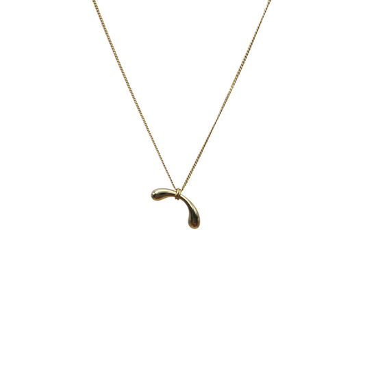 Gold necklace with a unique pendant on a white background