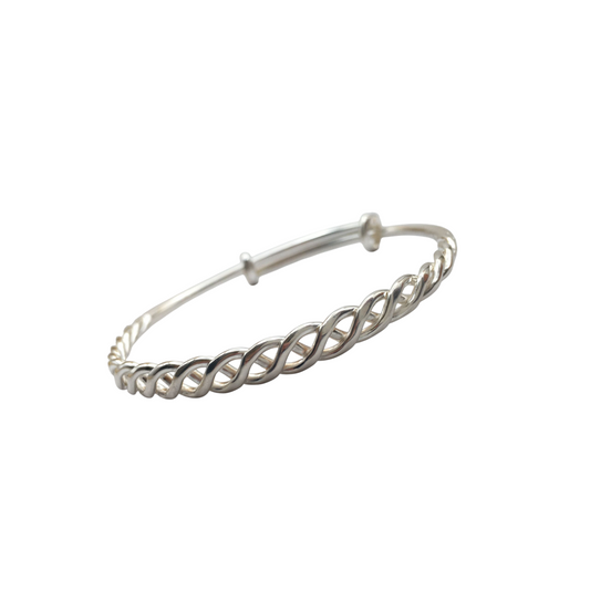 Silver bracelet with braided design on a white background