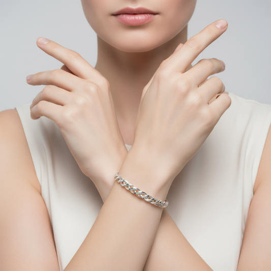 Silver bracelet with braided design on a white background