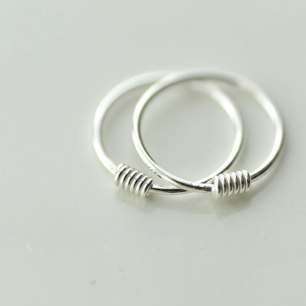 Silver hoop earrings on a light gray background