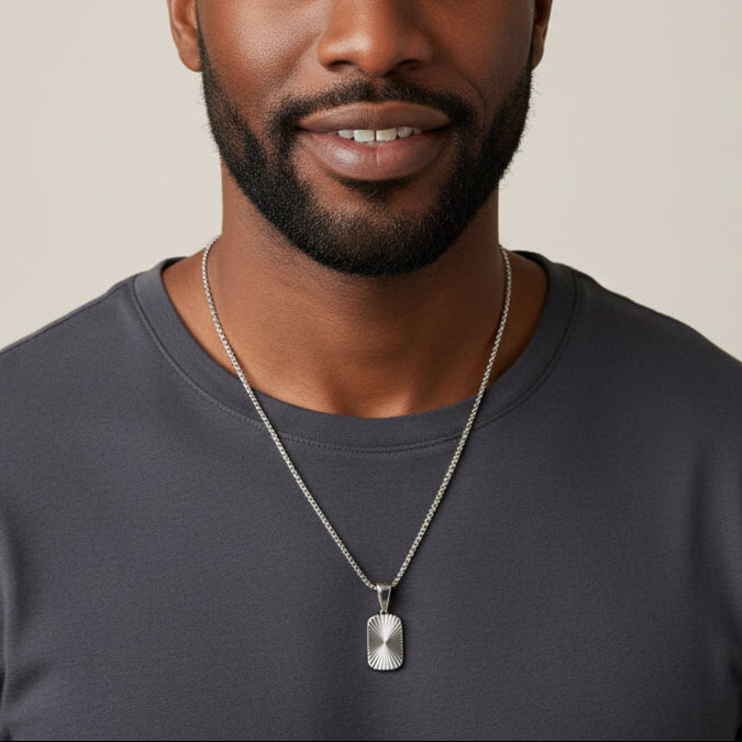 Silver necklace with a pendant on a white background