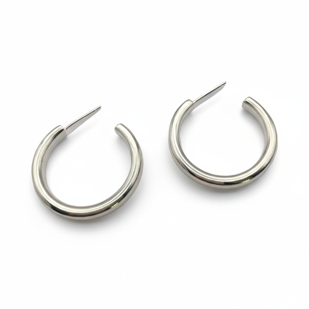 Pair of silver hoop earrings on a white background