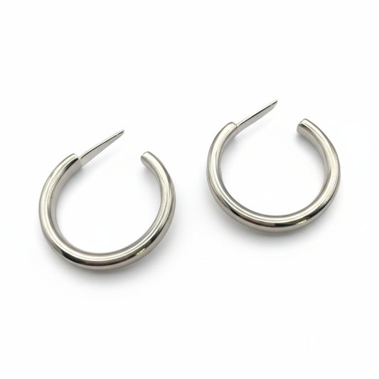 Pair of silver hoop earrings on a white background