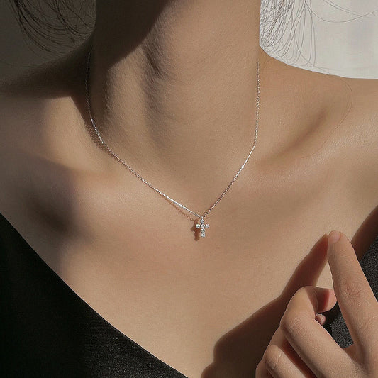 Necklace with a delicate pendant worn by a person