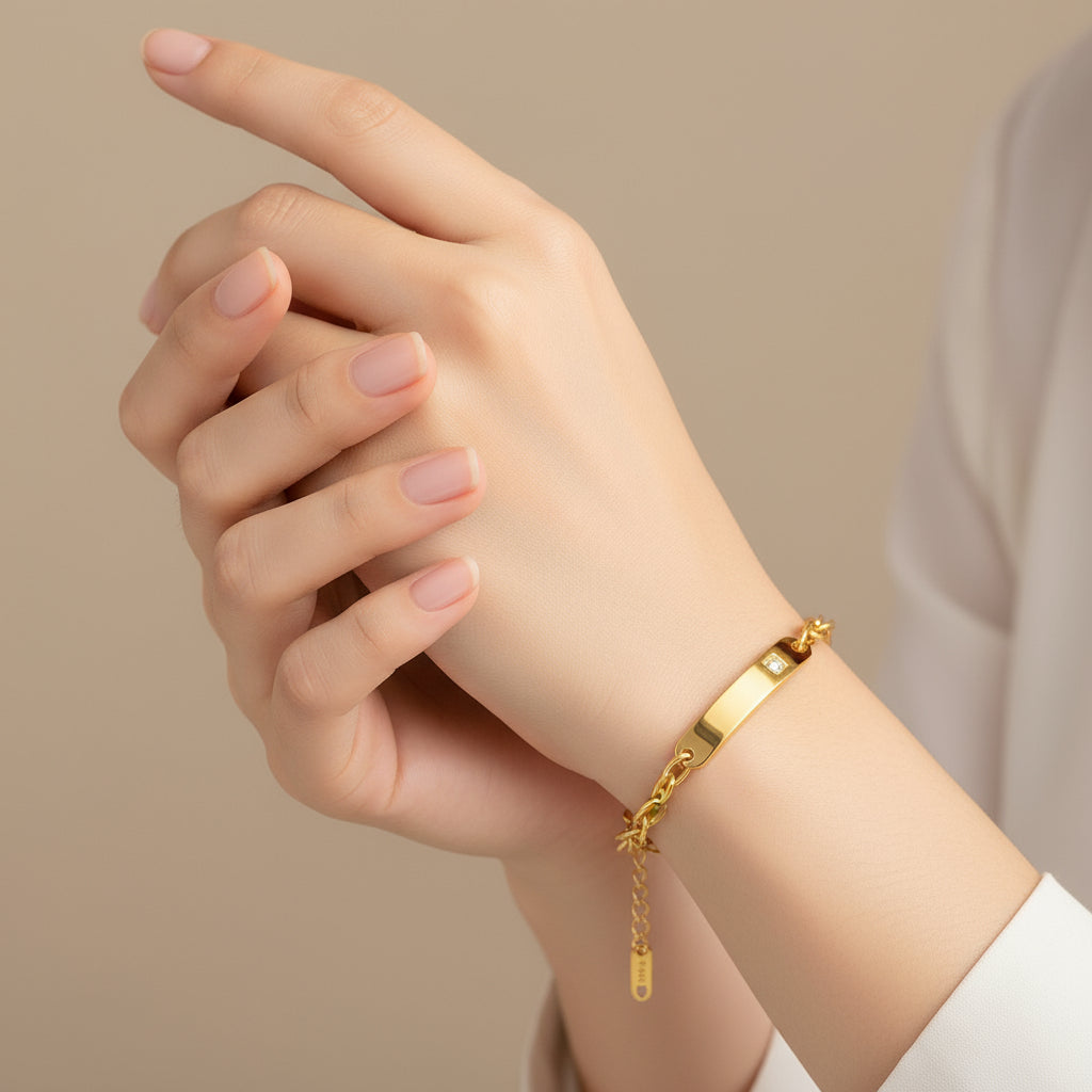 Gold chain bracelet with a diamond on a white background