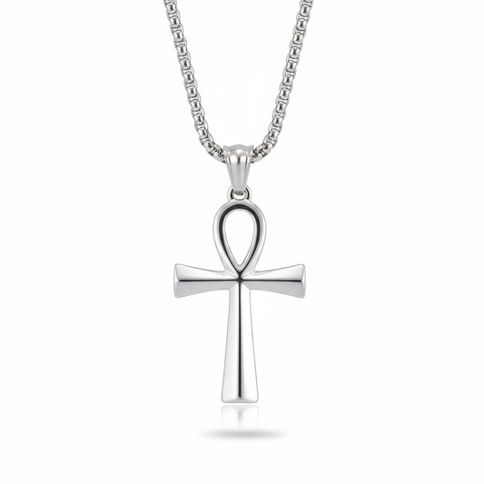 Silver cross pendant on a chain against a white background