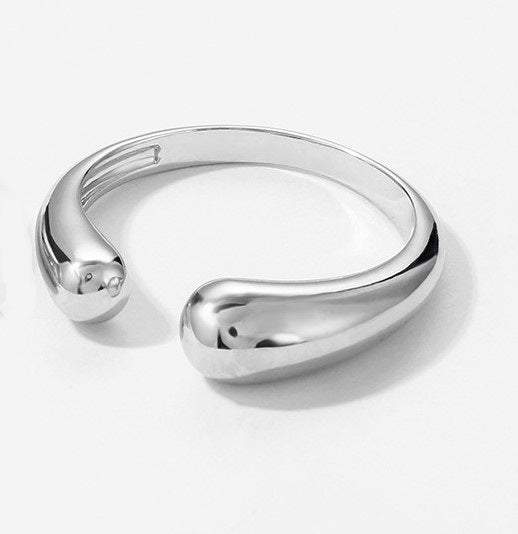 Silver ring with a modern design on a white background