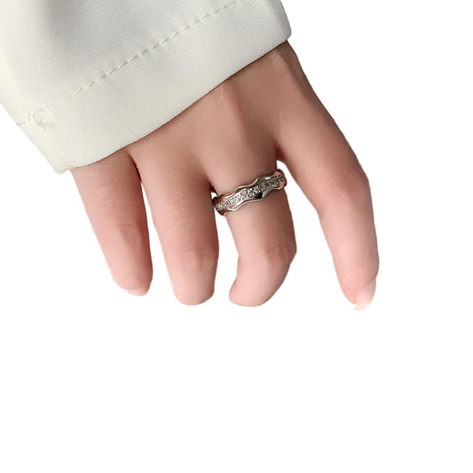 Hand wearing a ring on a book with text